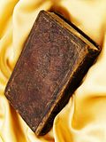  photo 1722174-818332-old-closed-book-at-the-golden-fabric-drapery.jpg