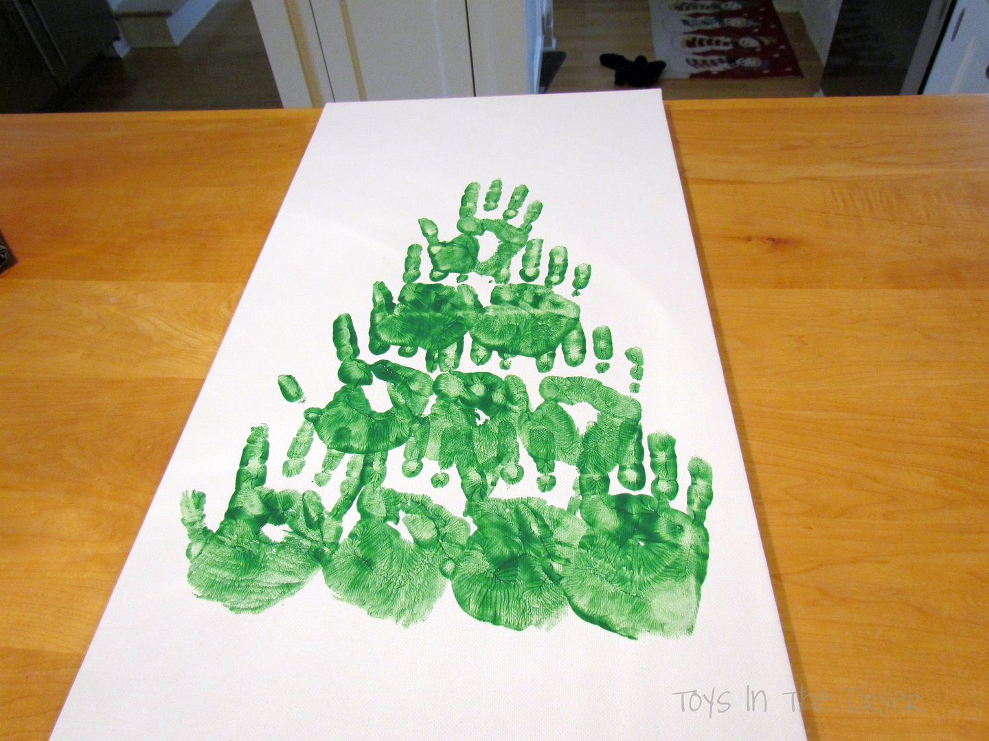 make a Christmas tree out of hand prints