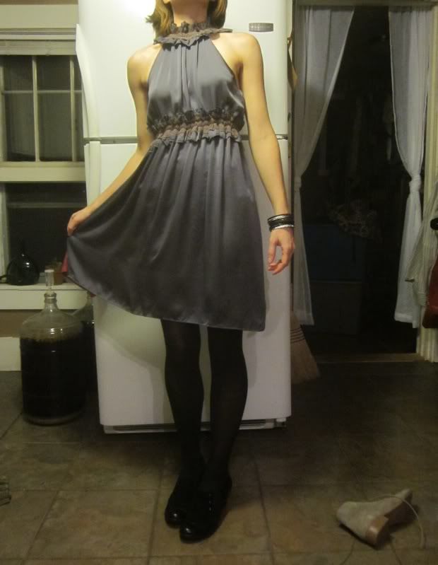 dress with more sort of purple ruffles about the neck and waist